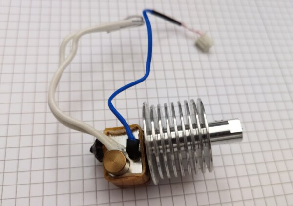 Stock hotend with heatbreak and cooling fins, removed from the printer